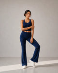 Model wearing Deep Navy Foldover Flare Pilates Pants in a sculptural front fit pose