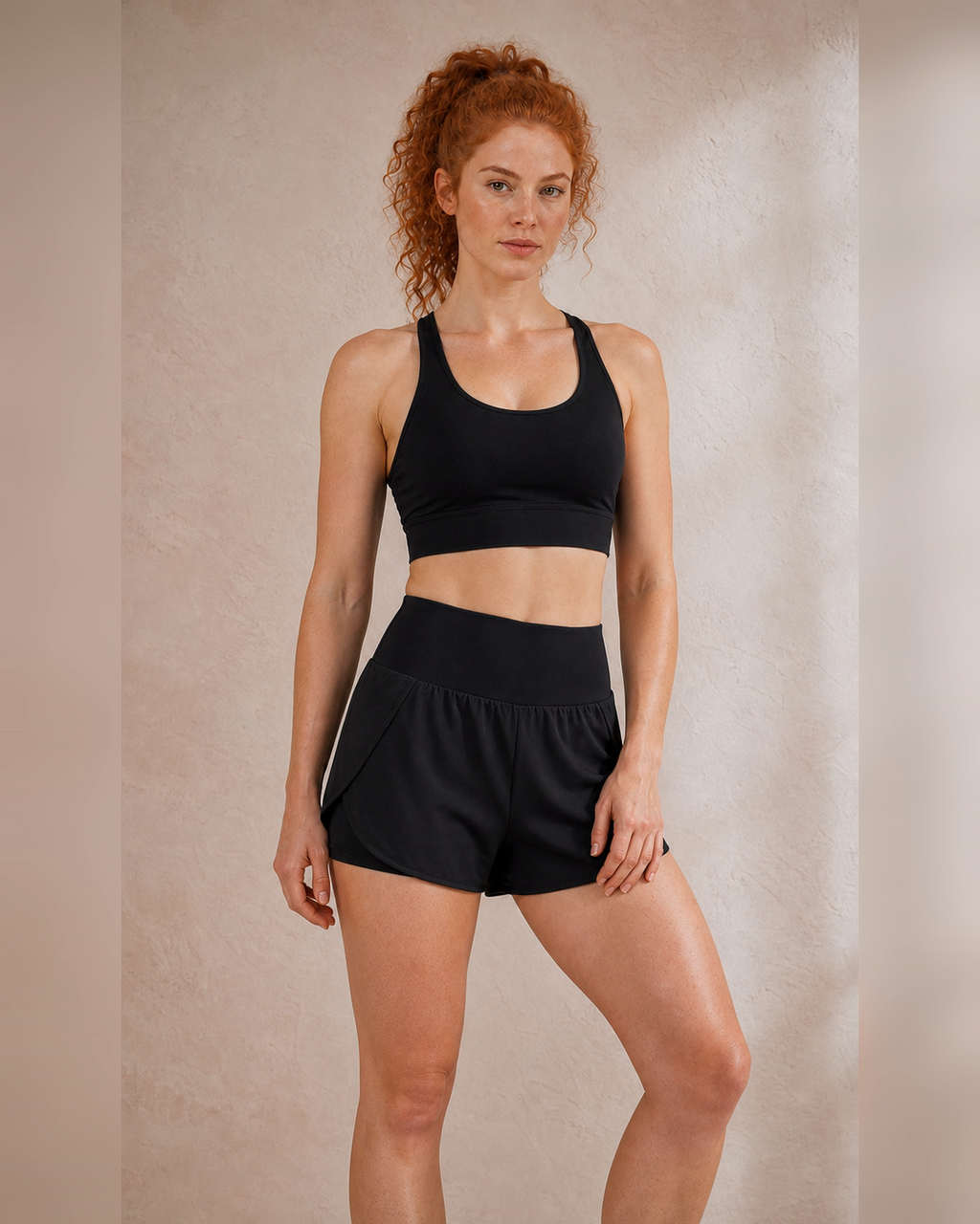 Front view of black double-layer running shorts with a loose outer shell.