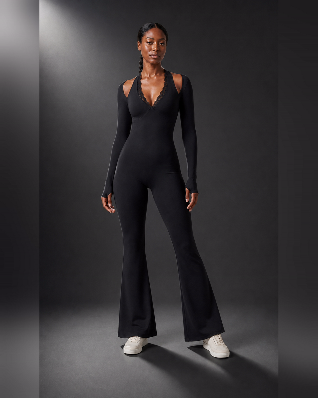 Front view of a black lace-trim one-piece with a short flared lower section.