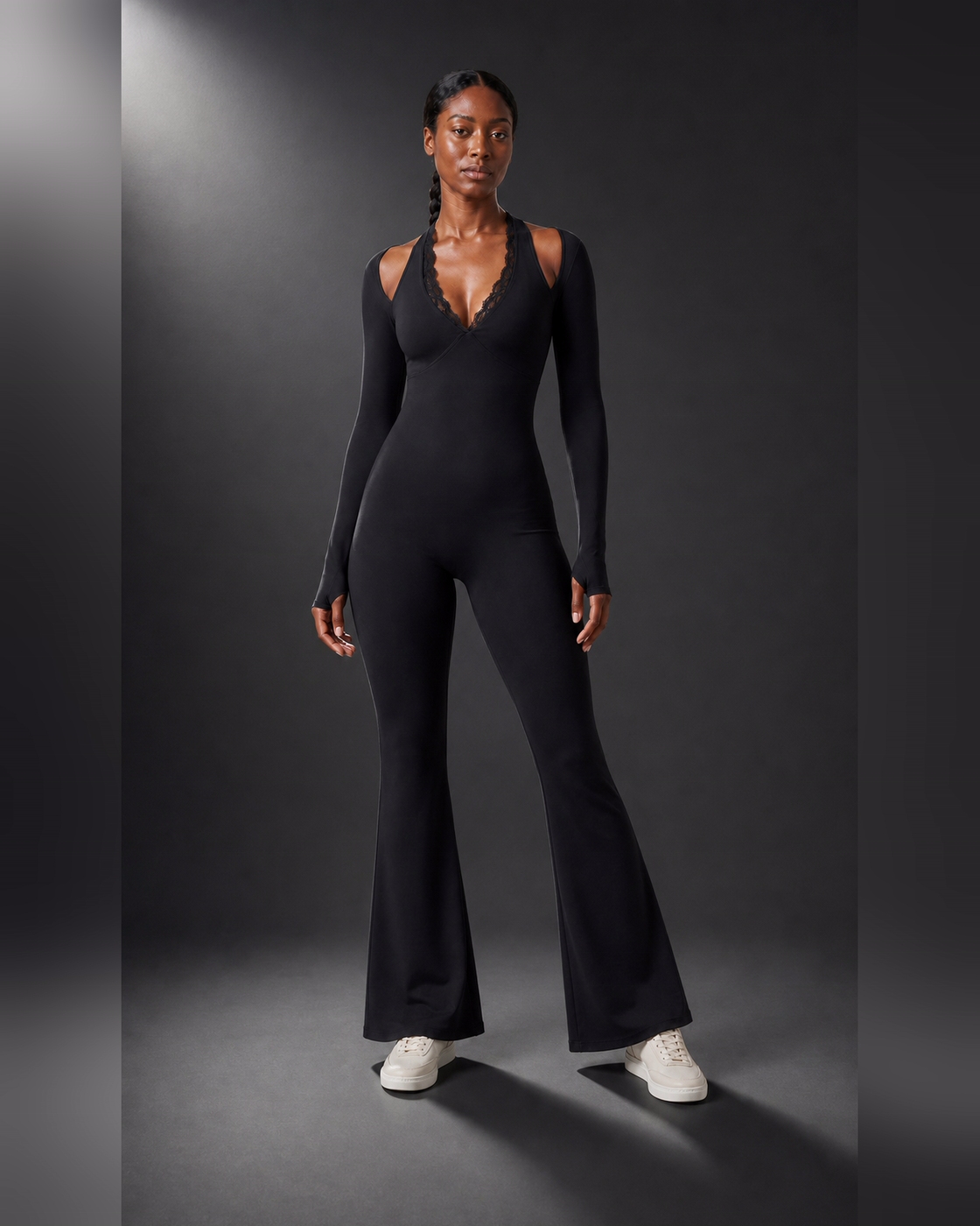 Front view of a black lace-trim one-piece with a short flared lower section.