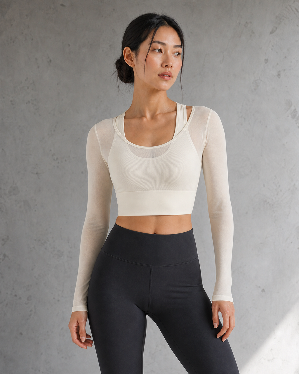 Model wearing an Ivory mesh-layer long-sleeve top in a daylight studio.