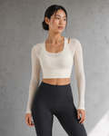 Model wearing an Ivory mesh-layer long-sleeve top in a daylight studio.