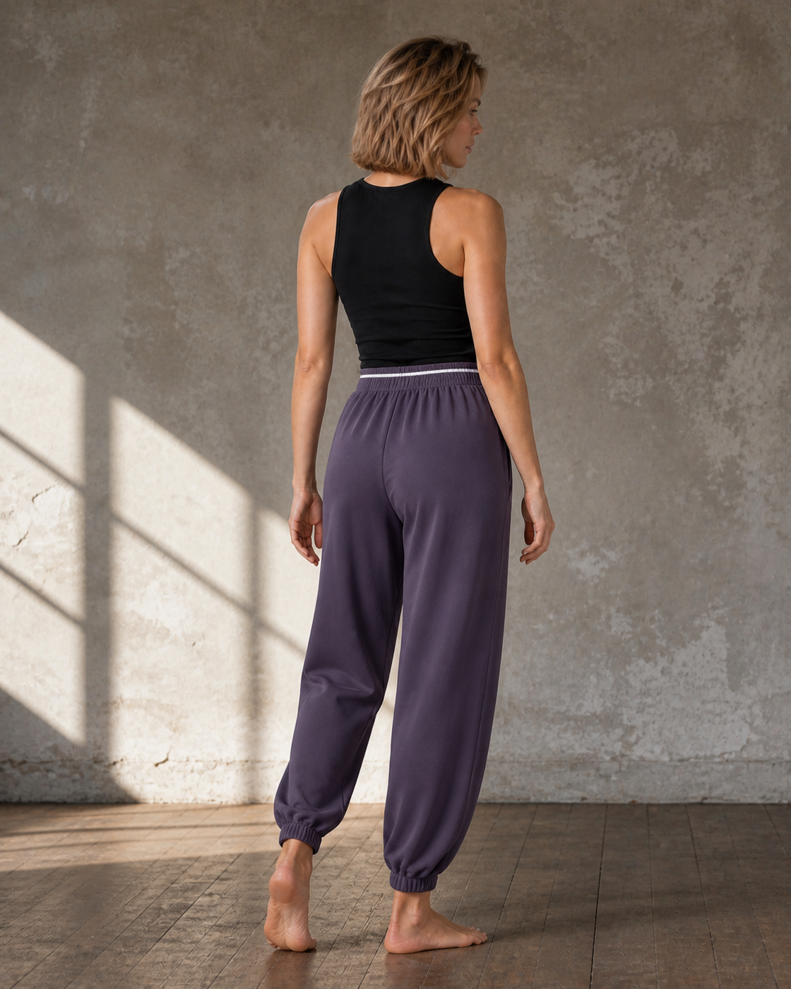 Rear view of Purple relaxed joggers with a striped gathered waistband.